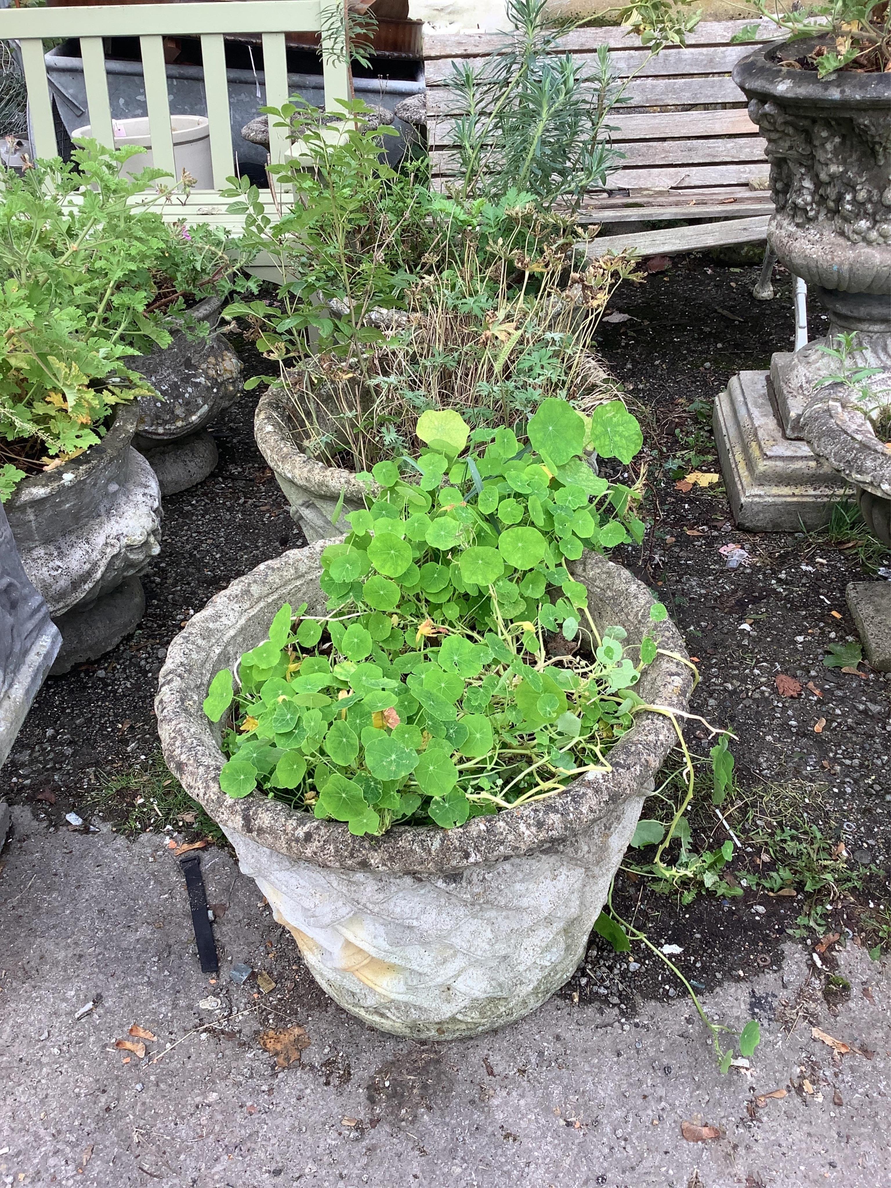 A set of three circular reconstituted stone garden planters, lattice work decoration to sides, diameter 58cm, height 44cm. Condition - fair